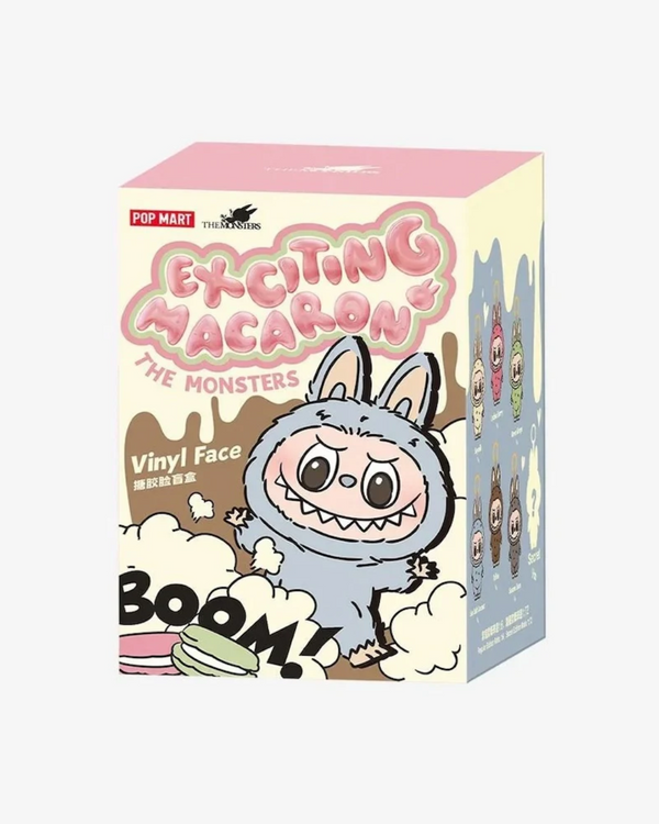 Box of 'Exciting Macaron The Monsters' vinyl figures with a cartoon character on a white background